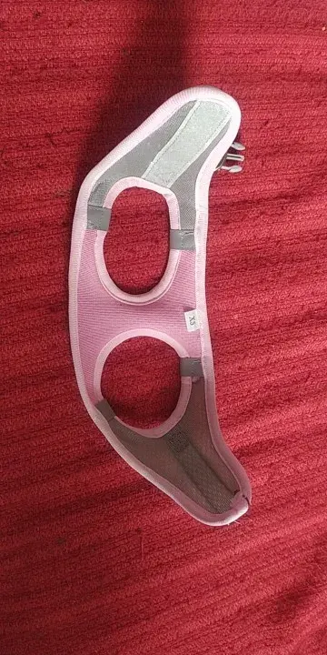 Pink mesh cat harness laid out flat, showing the leg openings and gray mesh panels, buyer photo