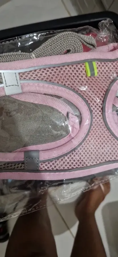 Pink mesh cat harness with reflective trim still in its clear plastic packaging, buyer photo